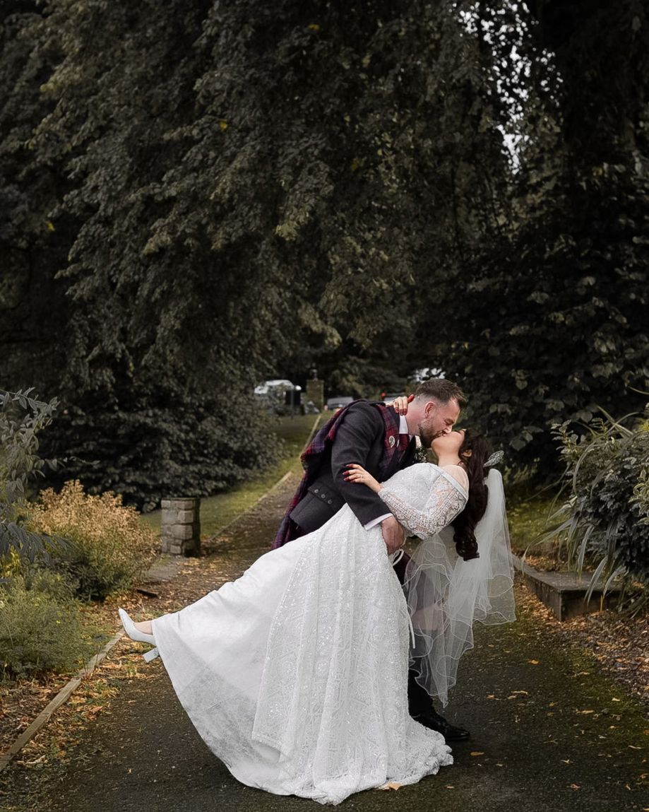 Groom dips bride for kiss